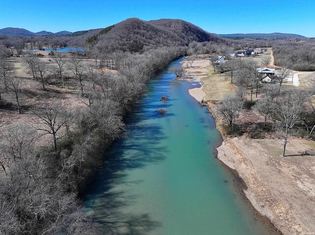 drone / aerial view with a water and mountain view