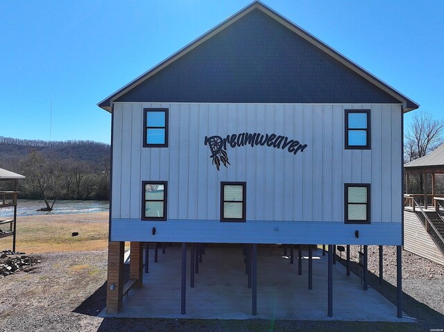 exterior space featuring board and batten siding and a water view