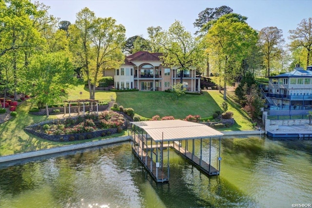 view of dock with a water view, a lawn, and boat lift