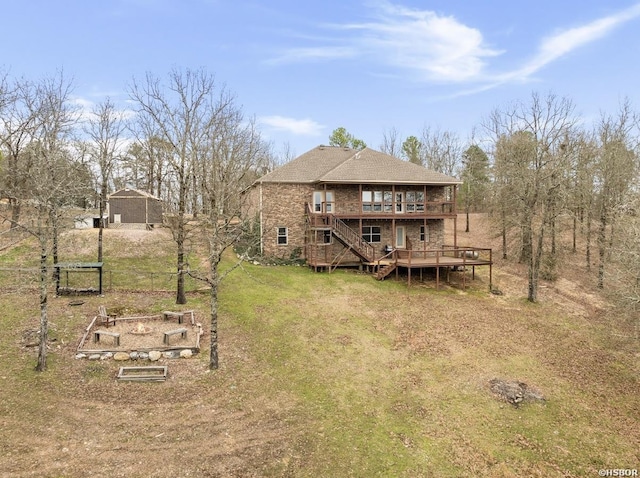 back of house with stairway, a garden, a deck, a lawn, and brick siding