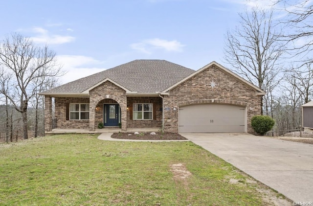 view of front of home featuring brick siding, an attached garage, driveway, and a front lawn