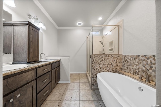 full bathroom featuring a sink, a soaking tub, a stall shower, and ornamental molding