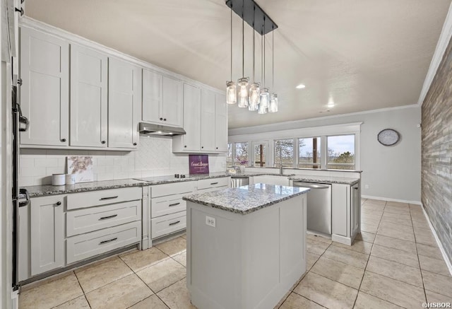 kitchen featuring ornamental molding, under cabinet range hood, a kitchen island, stainless steel dishwasher, and a peninsula