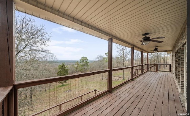 deck with a rural view and ceiling fan