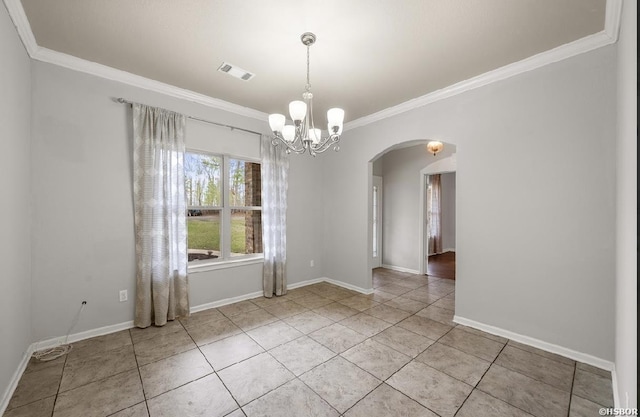 empty room featuring baseboards, arched walkways, and ornamental molding