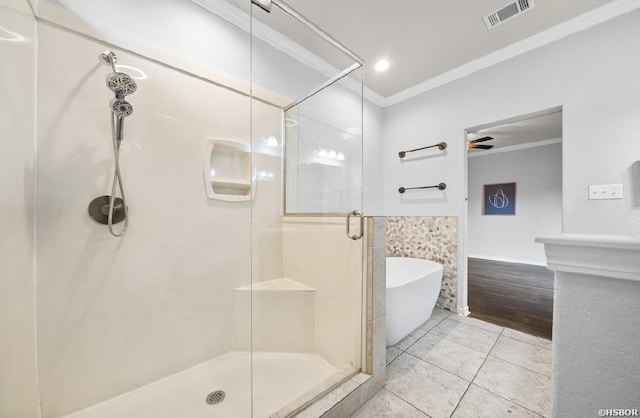 full bath featuring visible vents, a freestanding tub, tile patterned flooring, a shower stall, and crown molding