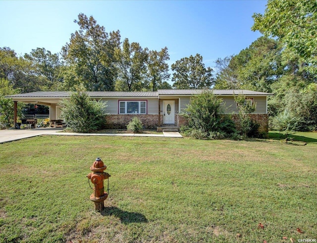 view of front facade featuring a carport, driveway, a front lawn, and brick siding