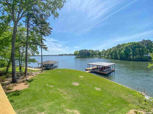 dock area featuring a water view and a yard