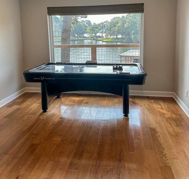 playroom featuring baseboards and wood finished floors