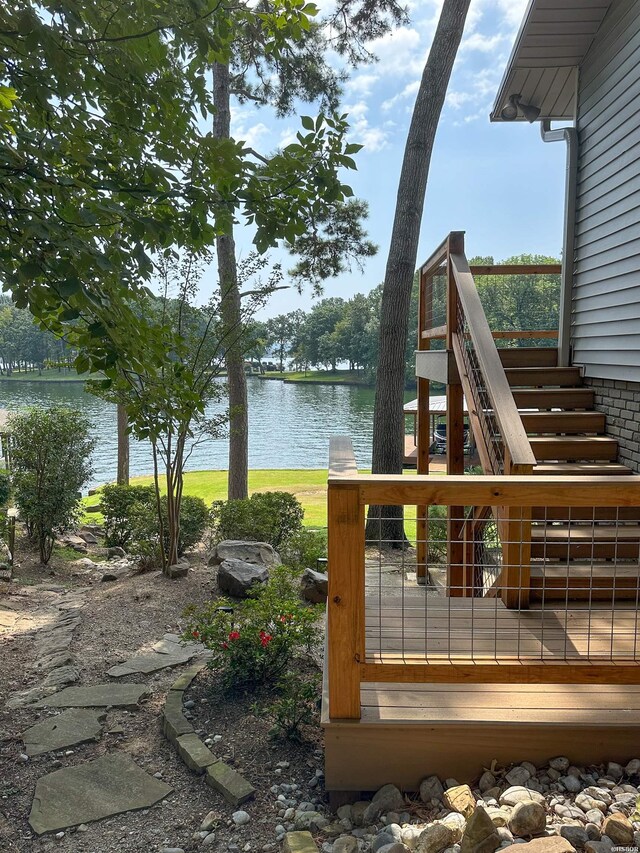 deck featuring stairs and a water view