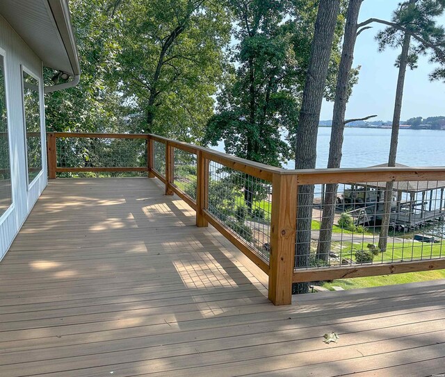 wooden terrace featuring a water view