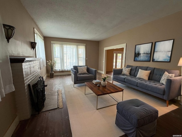 801 Crittenden St, Arkadelphia, AR 71923 - living room with a fireplace, baseboards, wood finished floors, and a textured ceiling