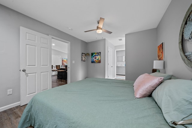 bedroom featuring visible vents, baseboards, dark wood-style floors, ensuite bath, and ceiling fan