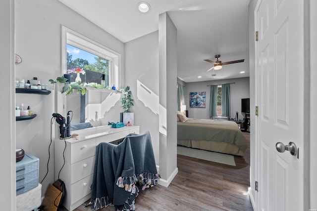 bedroom featuring recessed lighting, multiple windows, baseboards, and wood finished floors