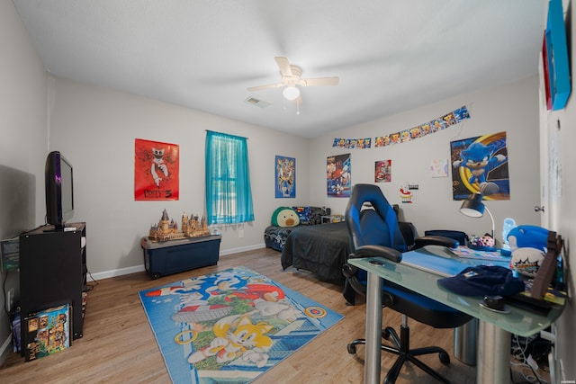 bedroom featuring visible vents, ceiling fan, baseboards, and wood finished floors