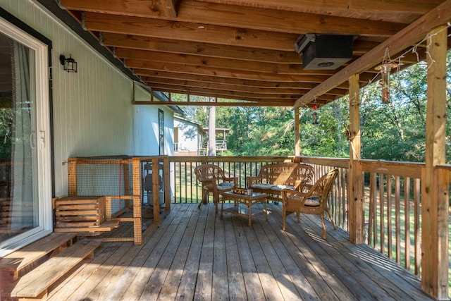 wooden terrace with outdoor dining area