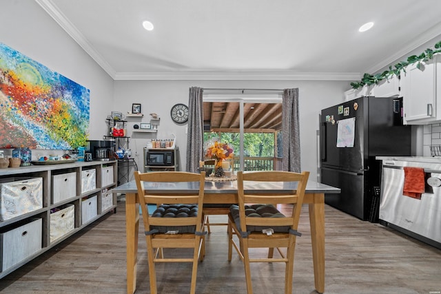 dining space featuring ornamental molding, wood finished floors, and recessed lighting