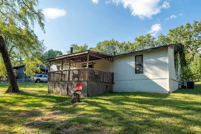 exterior space featuring cooling unit, a yard, and a deck