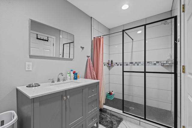 bathroom with a stall shower and vanity