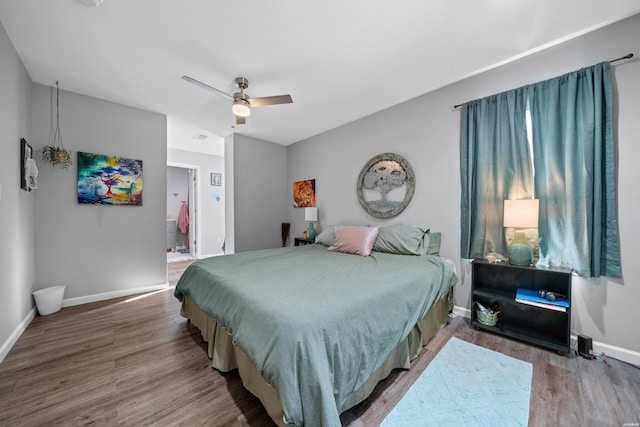 bedroom featuring wood finished floors, a ceiling fan, and baseboards