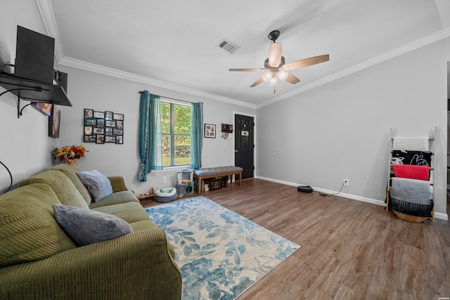 living area featuring ornamental molding, visible vents, baseboards, and wood finished floors