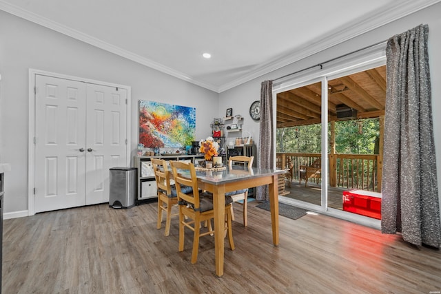 dining space with recessed lighting, crown molding, baseboards, and wood finished floors