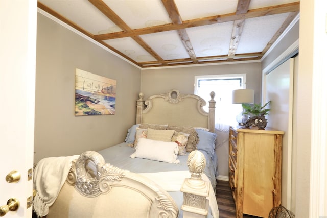 bedroom featuring beam ceiling, coffered ceiling, and wood finished floors