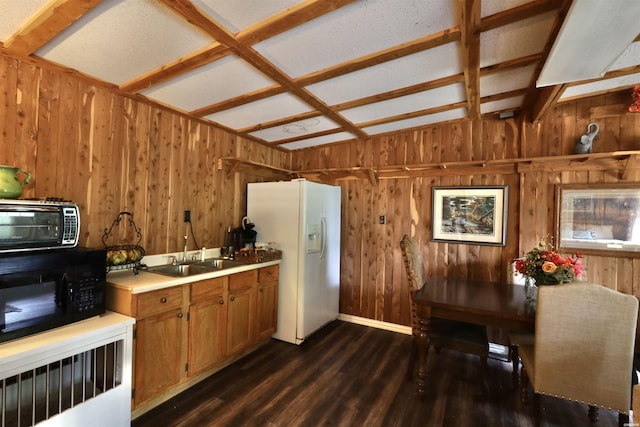 kitchen featuring black microwave, dark wood-style flooring, brown cabinets, white fridge with ice dispenser, and a sink