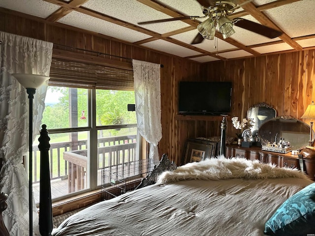 bedroom featuring coffered ceiling and wooden walls