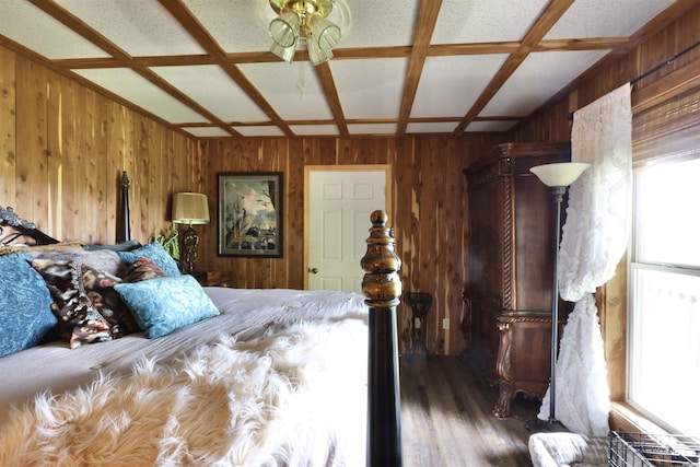bedroom featuring wood finished floors, coffered ceiling, and wood walls