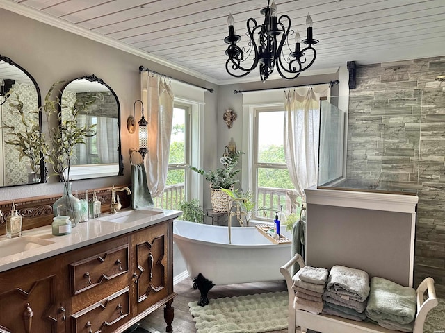 full bath with wood ceiling, a freestanding bath, crown molding, and a sink