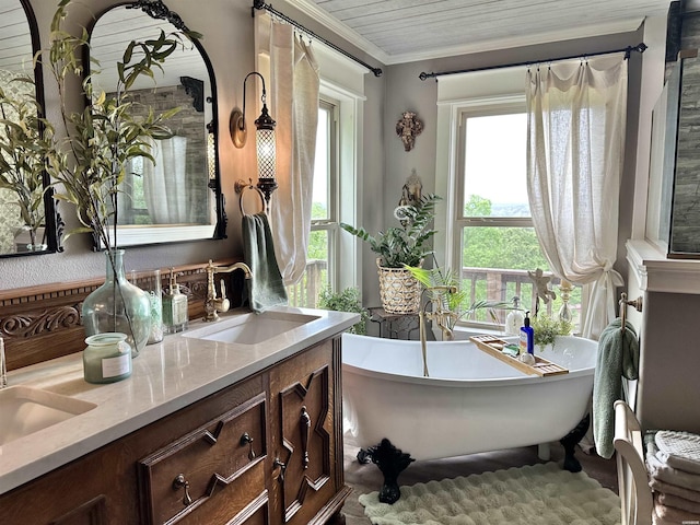 bathroom featuring double vanity, a soaking tub, crown molding, and a sink
