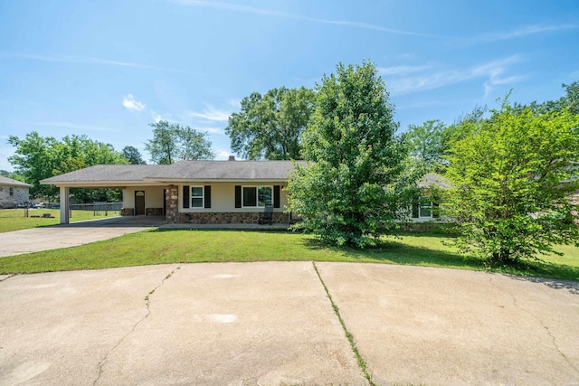 single story home with driveway, a carport, stone siding, and a front lawn