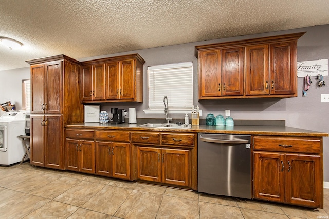 2939 Finch Rd, Bismarck, AR 71929 - kitchen featuring stainless steel dishwasher, a sink, dark countertops, a textured ceiling, and separate washer and dryer