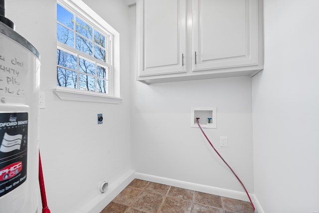 clothes washing area with electric dryer hookup, hookup for a washing machine, cabinet space, and baseboards