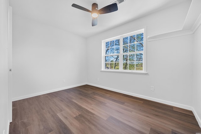 spare room with visible vents, ceiling fan, baseboards, and wood finished floors