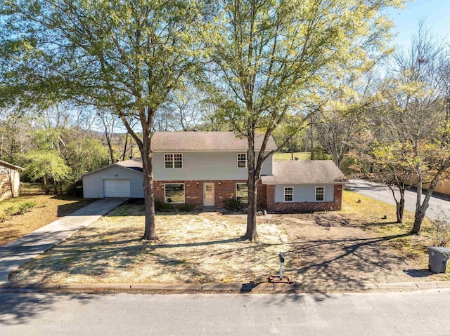 view of front of home with a garage, driveway, and brick siding