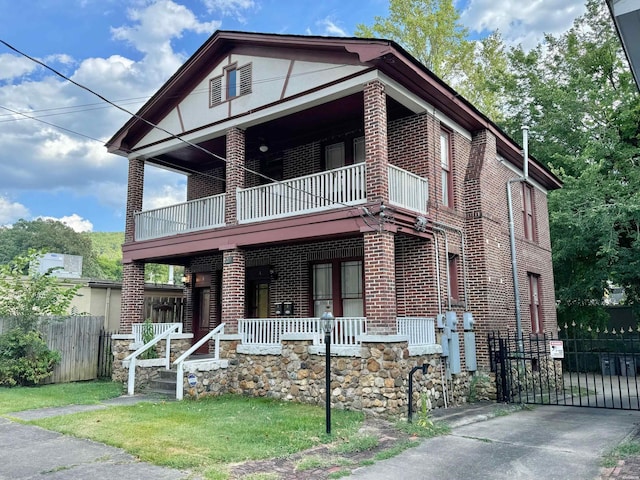 view of front facade featuring a porch, brick siding, fence, and a balcony