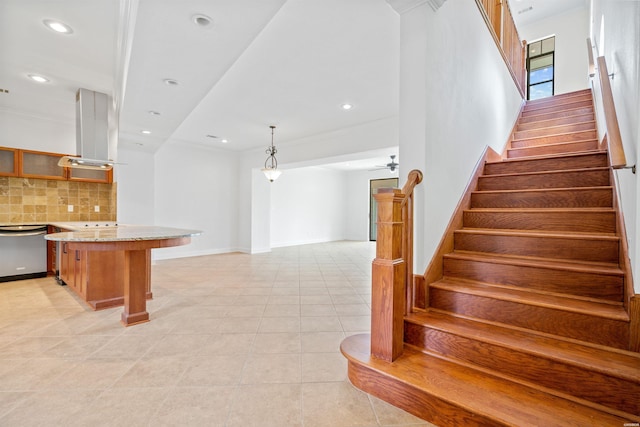 interior space with recessed lighting, ornamental molding, ceiling fan, baseboards, and tile patterned floors