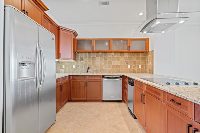 kitchen with light stone counters, visible vents, appliances with stainless steel finishes, glass insert cabinets, and island range hood