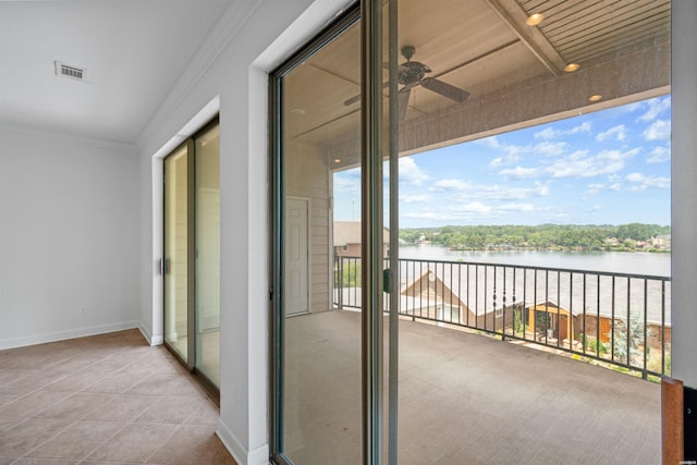 balcony featuring a water view, ceiling fan, and visible vents