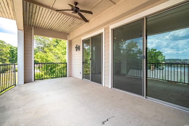 view of patio / terrace with a ceiling fan and a water view