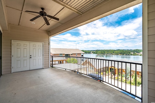 balcony featuring a ceiling fan and a water view