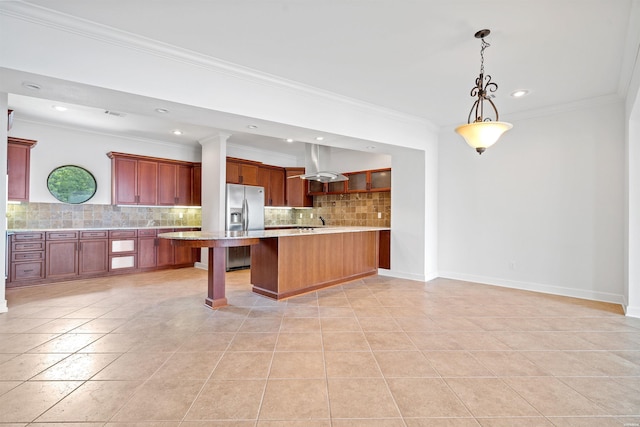 kitchen featuring decorative light fixtures, baseboards, light countertops, a kitchen breakfast bar, and stainless steel fridge with ice dispenser