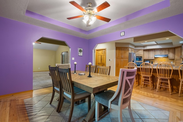 111 Black Oak Ct, Hot Springs, AR 71913 - dining space featuring a raised ceiling, light wood finished floors, arched walkways, and ceiling fan
