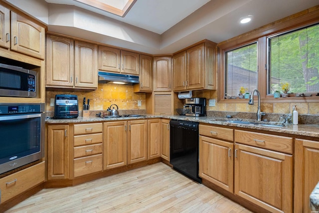 111 Black Oak Ct, Hot Springs, AR 71913 - kitchen with appliances with stainless steel finishes, light stone counters, light wood-style floors, under cabinet range hood, and backsplash