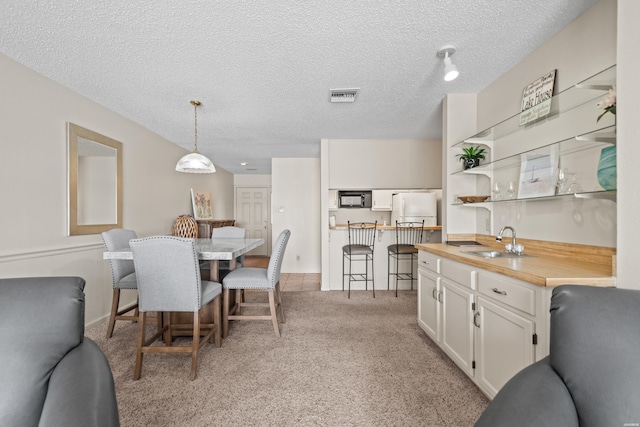 5371 Central Ave Unit 6G, Hot Springs, AR 71913 - dining area with a textured ceiling, wet bar, and light carpet