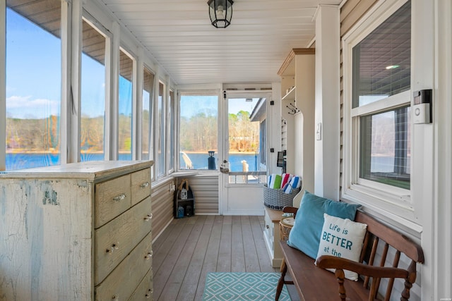 sunroom / solarium with a water view