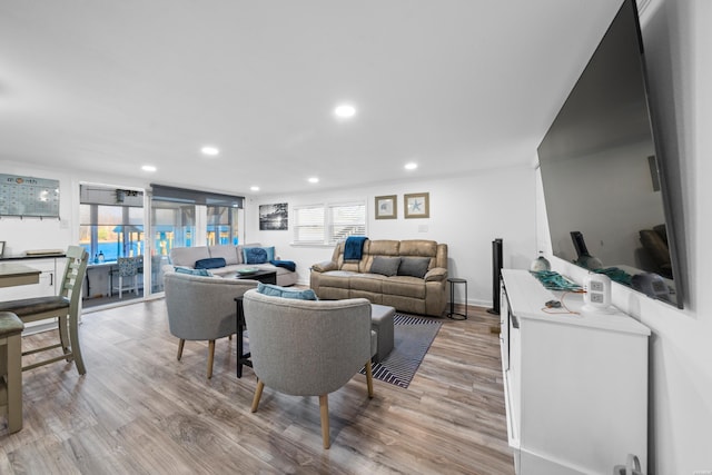 living area featuring plenty of natural light, recessed lighting, and light wood-type flooring