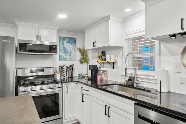 kitchen with a sink, appliances with stainless steel finishes, crown molding, and white cabinetry